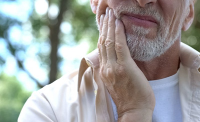 Man rubbing his jaw