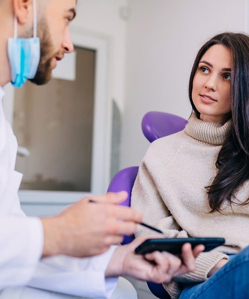 Happy dental patient reclining in treatment chair