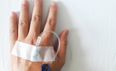 Close-up of IV in person’s hand