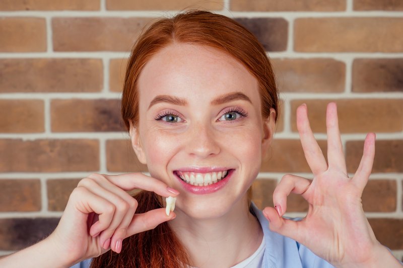 Patient smiling after tooth extraction